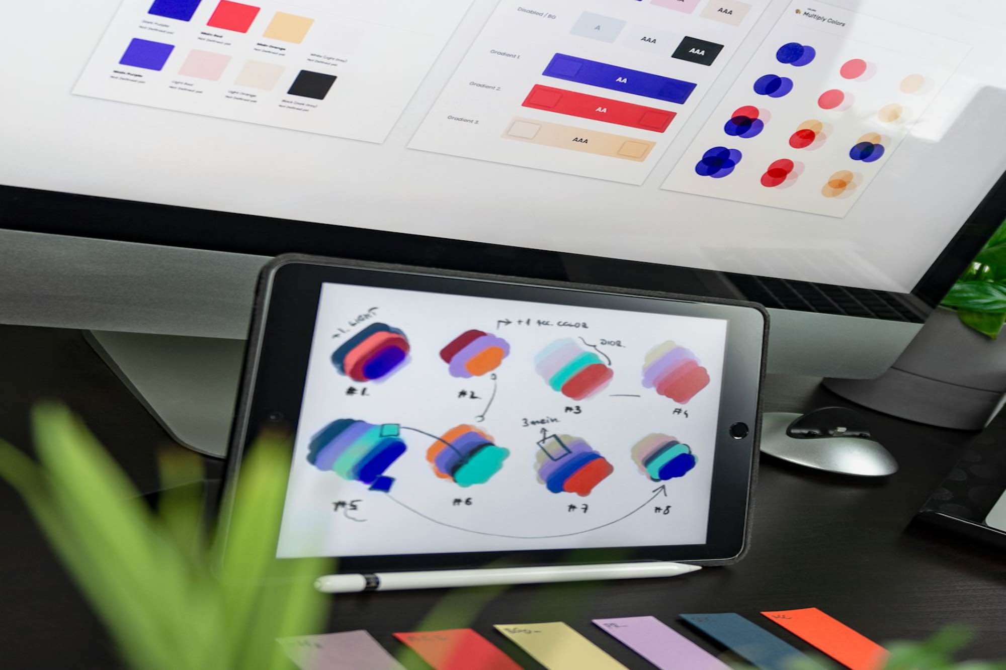 Multiple color palettes for graphic design displayed on an Mac and Apple iPad